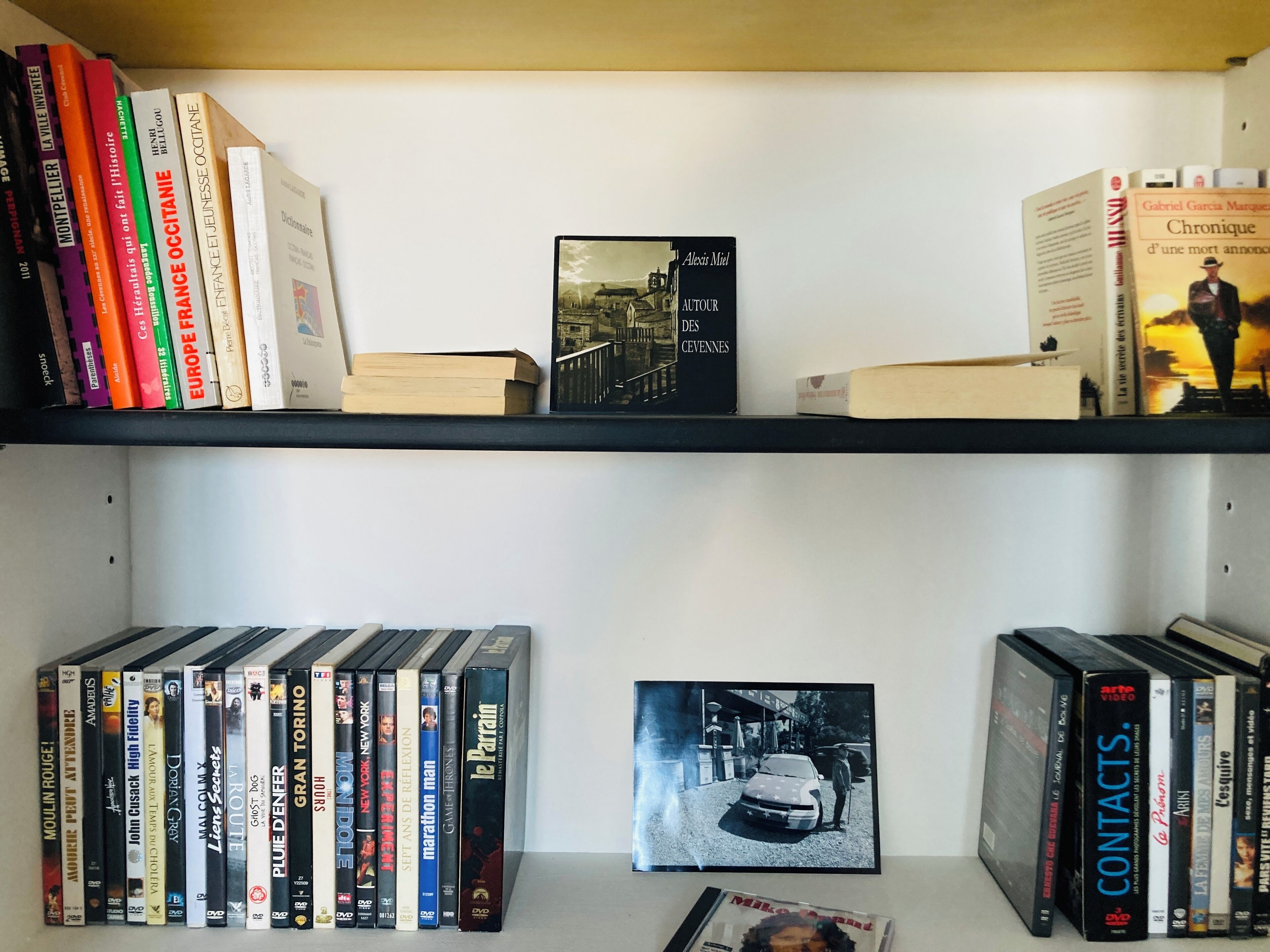 A bookshelf with books and DVDs.
