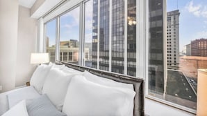 Een moderne hotelkamer met een groot raam en uitzicht over de stad.