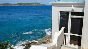 A coastal building with a view of the ocean and distant islands. - Serene Escape + 3 Mins to Beach + Dining (St. Thomas)