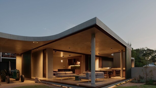 Une maison moderne dotée d’un espace de vie à aire ouverte, d’une cuisine et d’une terrasse.