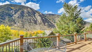 A deck with metal chairs and a table, overlooking a mountainous landscape with autumn-colored trees. - Mtn-View Cabin w/ Private Hot Tub in Georgetown! (Georgetown)