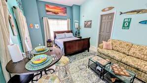 A bedroom with a bed, a window with curtains, a wall clock, and a door. - Tranquil studio with AC in quiet Merritt Island neighborhood (Merritt Island)