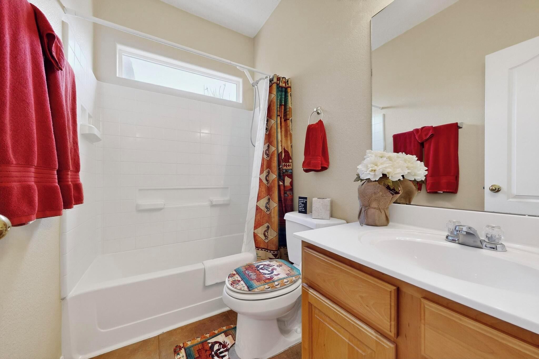 A bathroom with a bathtub, toilet, and sink.