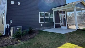 A modern building with a dark exterior, large windows, and a covered entrance. - 4BR Knightdale Home • Fast Wi-Fi • Near Downtown Raleigh (Knightdale)