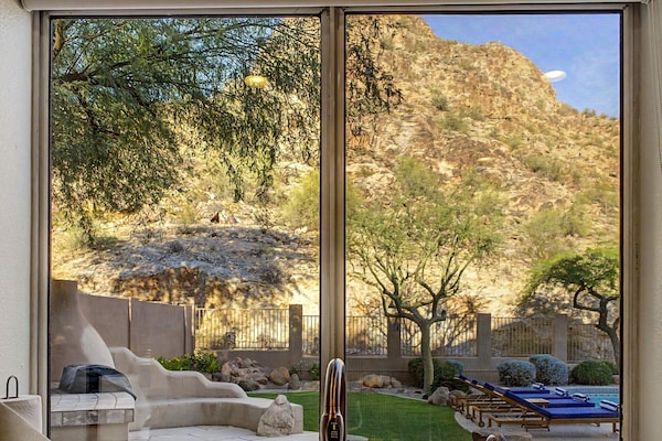 Amazing Kitchen View: Marvel at stunning mountain vistas and the backyard while prepping meals in style!