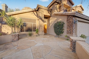 A house with a stone facade, a garage, and a patio area with stone flooring. - Heated Saltwater Pool, Mtn View, King Beds, Games, Near Golf & Hiking, Sleeps 10 (Phoenix)