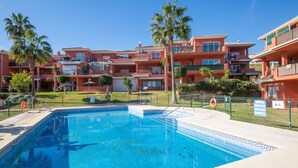 A swimming pool with a tiled deck, surrounded by a fence. - Manilva Gardens G.A6 (Manilva)