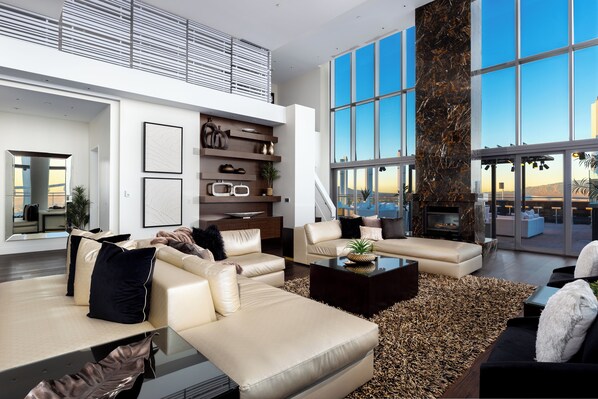 A spacious living area with a large window, a fireplace, and a modern interior design. - 360° Views/ Jacuzzi /4 Kings Vegas Strip 5 min (Las Vegas)