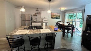 A modern kitchen with granite countertops, stainless steel appliances, and pendant lighting. - LUXURY GOLF GETAWAY DOWNTOWN BOISE (Boise)