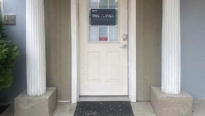 A white door with a sign that reads "THE LOVER'S".