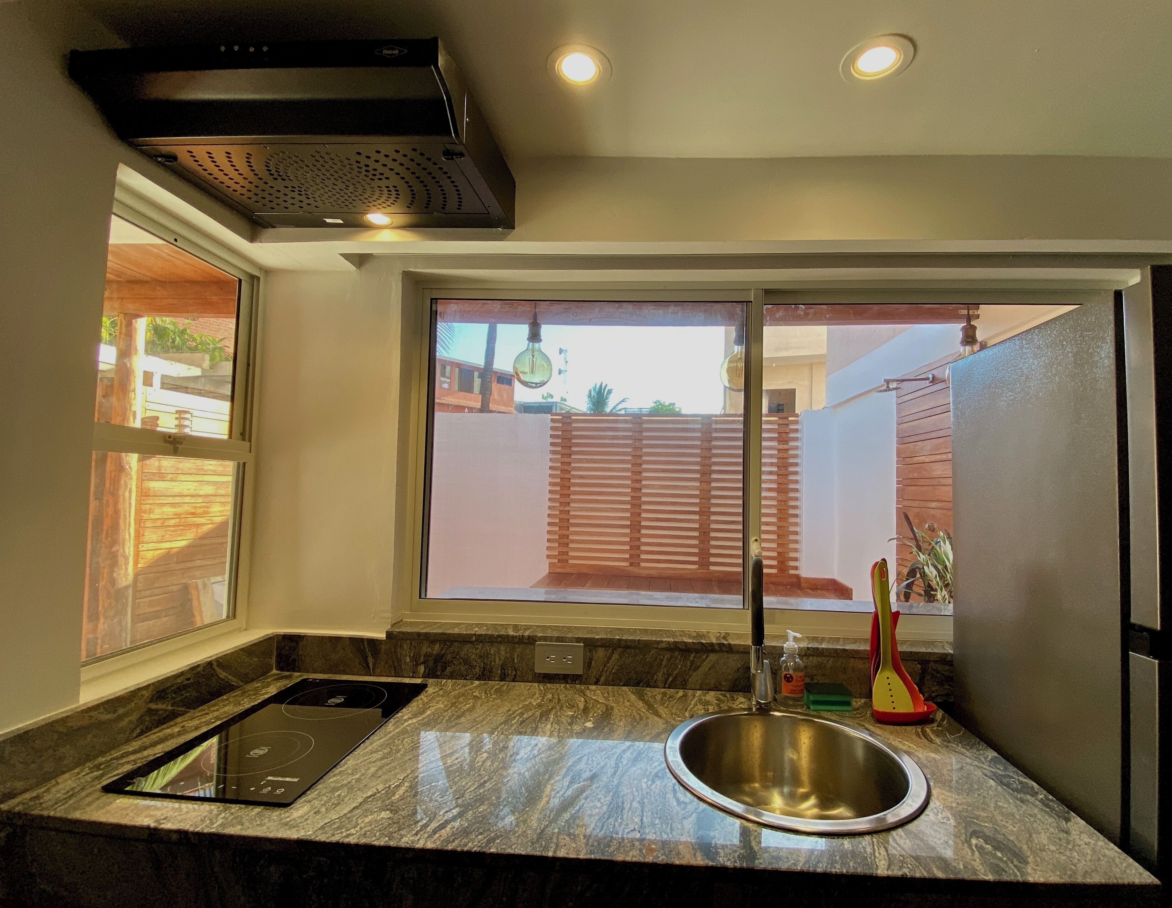 Fridge, microwave, coffee/tea maker, cookware/dishes/utensils