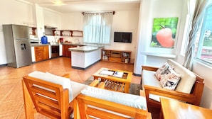 A compact living space with a kitchen, dining area, and a living room. - Spacious two-bedroom suite with a balcony (Puerto Ayora, Santa Cruz Island)