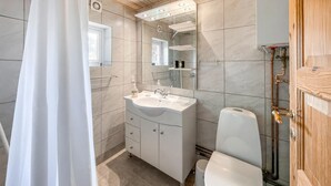 A bathroom with a shower, toilet, and sink. - 1 bedroom lovely home in Vig (Vig)
