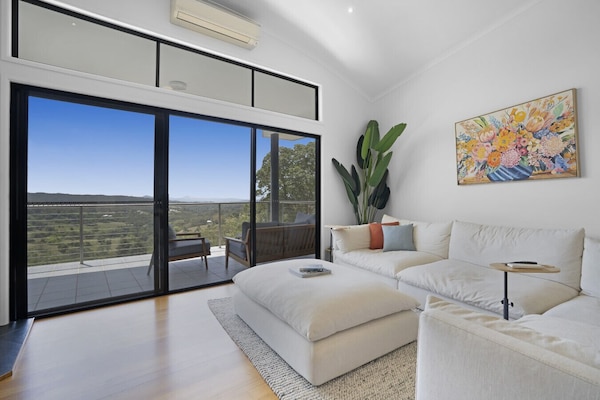 Open plan living room with balcony access and indoor fireplace