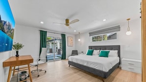A modern bedroom with a large bed, a desk, and a chair. - Foosball, Hot Tub, Big Backyard, Disneyland, AN12 (Anaheim)