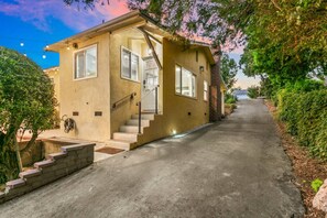 A single-story house with a front entrance, a staircase leading to the door, and a driveway. - Rooftop View, Spacious Yard, 19 min Disney, OR3 (Orange)