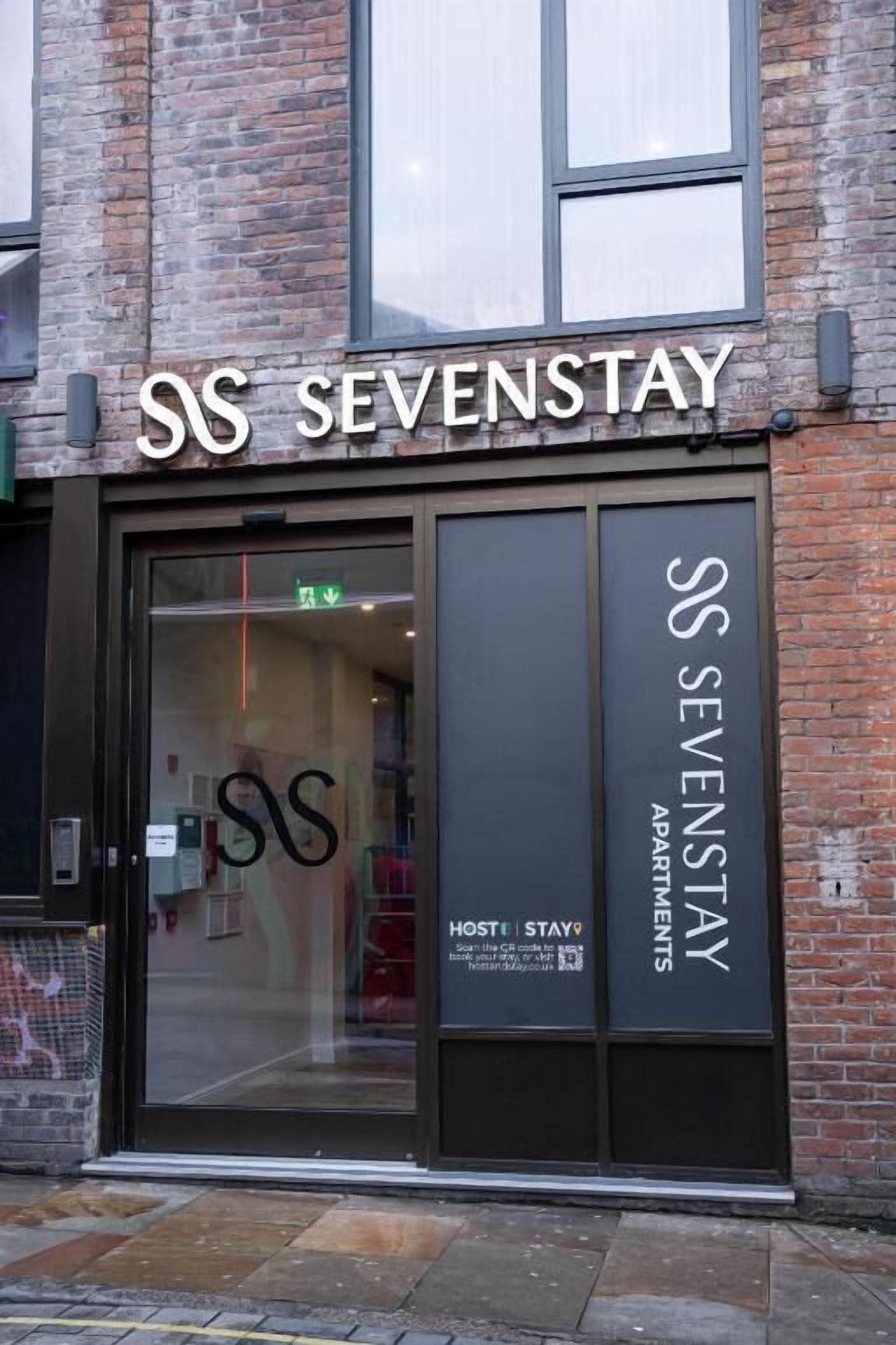 The exterior of a building with the signage 'SS SEVESTAY' and 'SS SEVENSTAY APARTMENTS'.