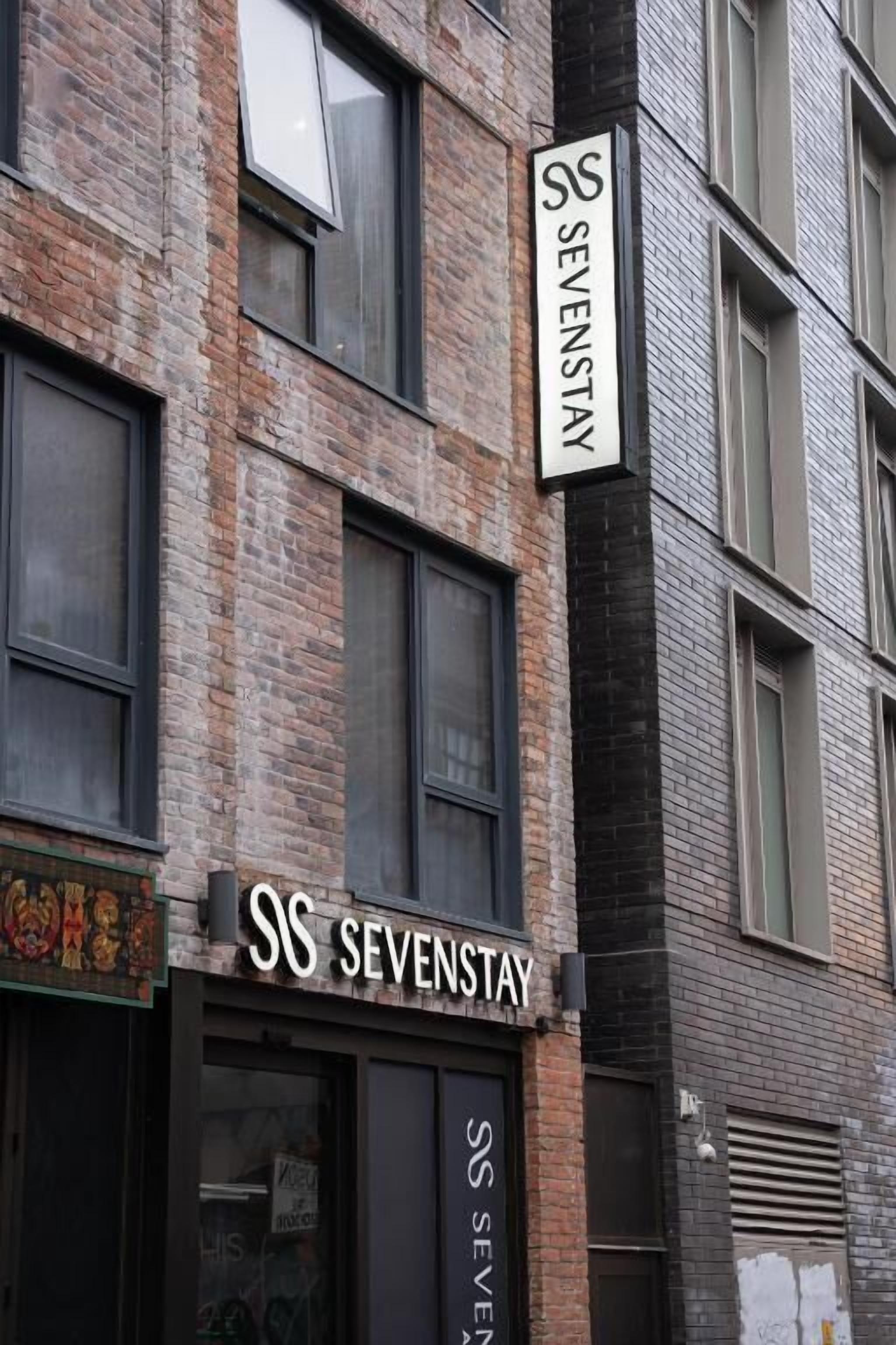 A building with a sign reading "SS SEVENSTAY" on the facade.