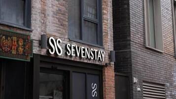 A building with a sign reading "SS SEVENSTAY" on the facade.