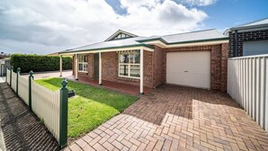 A residential property with a brick exterior, a covered porch, a garage, and a well-maintained lawn. - Captivating in Camden—A Well-located Family Haven (Camden Park)
