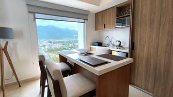 Fridge, microwave, cookware/dishes/utensils, dining tables