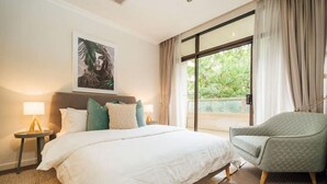 A hotel room with a large bed, two bedside tables with lamps, a chair, a window with curtains, and a painting on the wall. - Serene on Grenfell - A Vibrant City Stay (Adelaide)