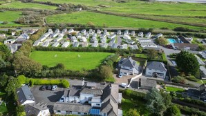 A residential area with houses and a large green field.
