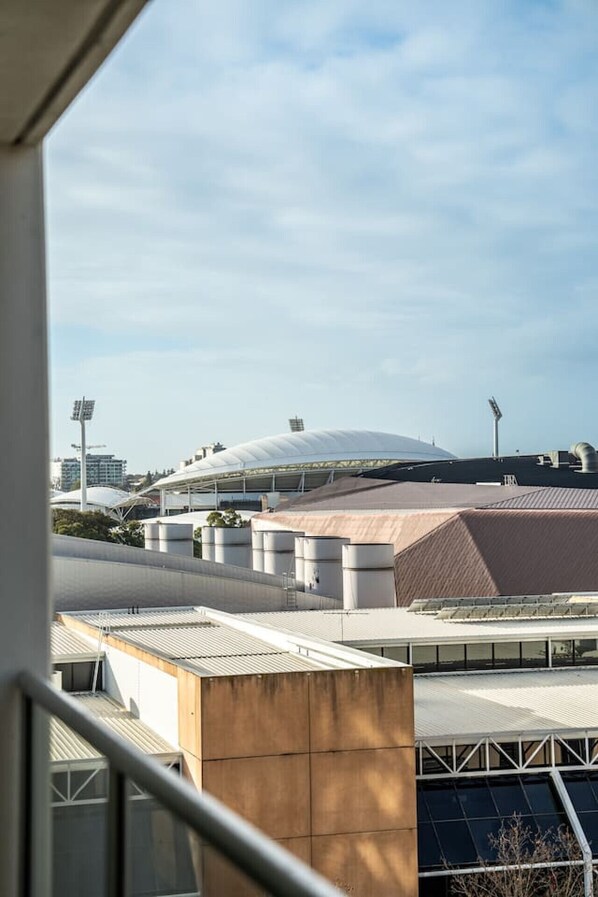 A modern building with a large dome structure, multiple cylindrical tanks, and a metal roof.