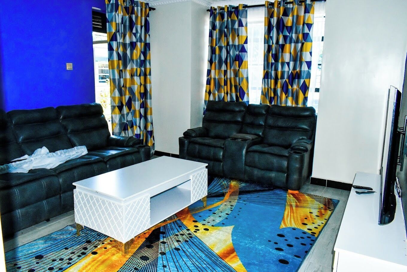 Family Apartment, City View | Living area | 24-inch Smart TV with digital channels