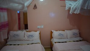 A room with two beds, each with a pillow labeled 'Dennis'. - Denniz Guest House Bungoma (Bungoma)