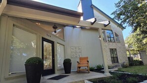 A house with a front door, a mailbox, a bench, and a small garden area. - Haven Getaway Inground Pool Inground Hot tub Family (Belton)