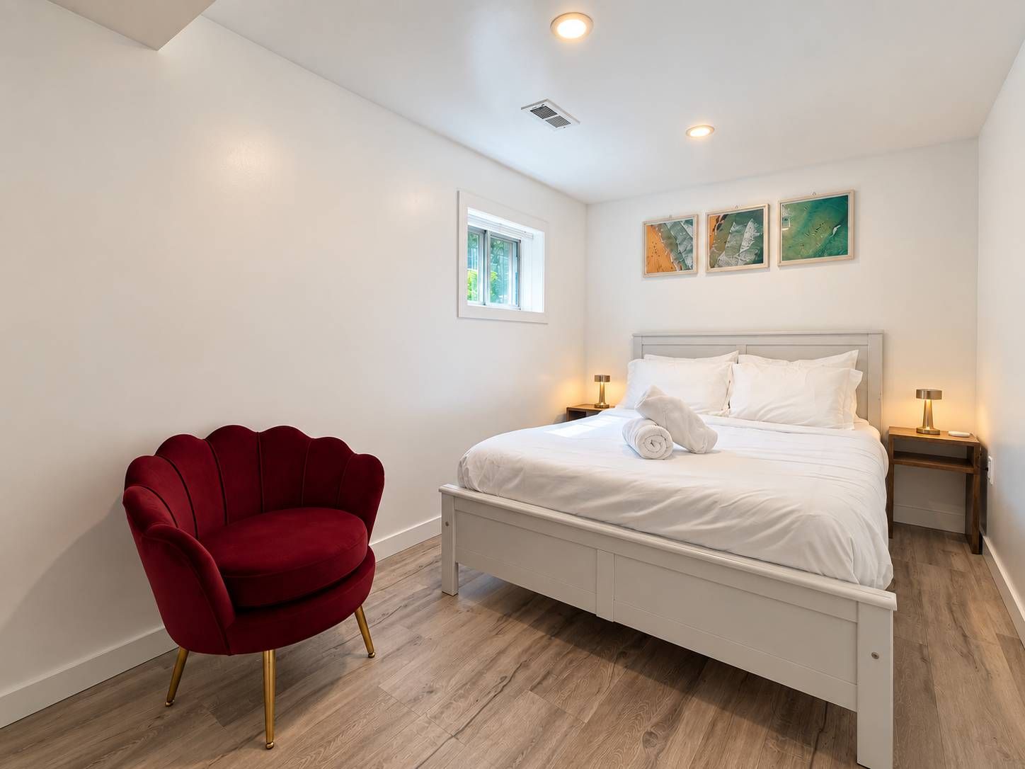 Inviting second bedroom with full-size bed, fresh linens & cozy accent chair.