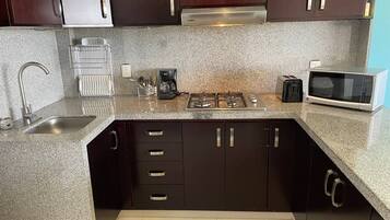 Fridge, microwave, stovetop, coffee/tea maker