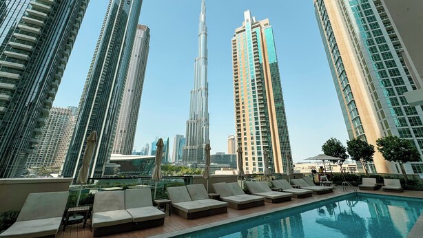 A rooftop pool area with lounge chairs and a view of tall skyscrapers. - Act 1 Act 2 Towers by DVH Luxe Retreats (Dubai)
