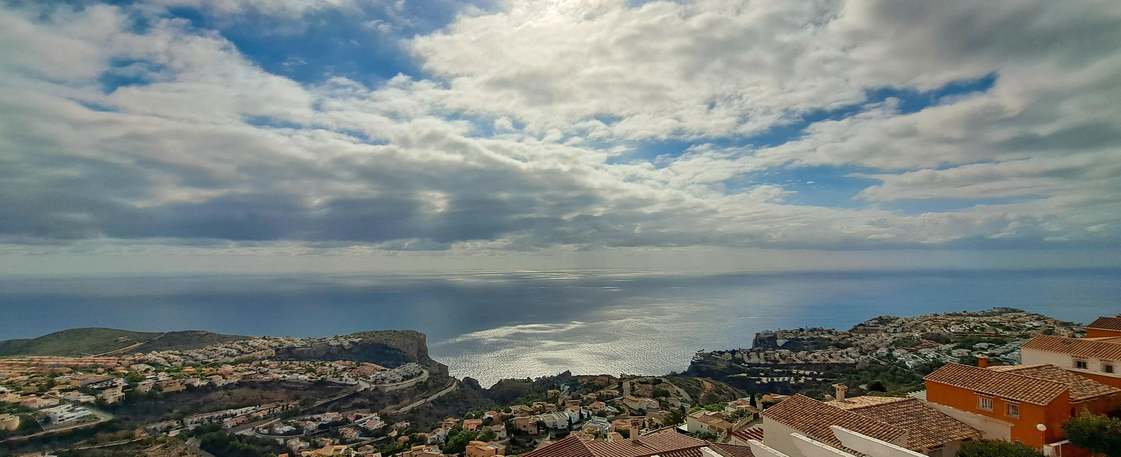A coastal town with a prominent cliff and a view of the sea.