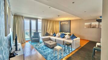 Deluxe Apartment, Balcony, City View | Living area | 43-inch flat-screen TV with cable channels