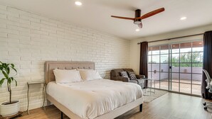 A spacious bedroom with a large bed, a ceiling fan, and a view through a sliding glass door. - Mtn-View Townhome w/ Pools: 5 Mi to Sabino Canyon! (Tucson)