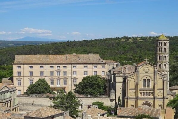 A historic building with a prominent tower and a large courtyard.
