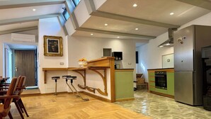 Un'ampia cucina con un'isola in legno, un frigorifero e un forno a microonde.