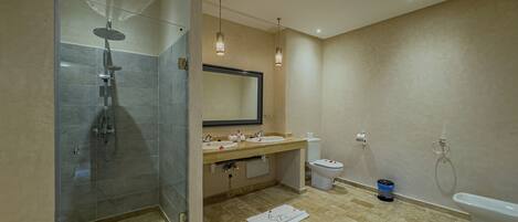A modern bathroom with a glass-enclosed shower, a vanity with dual sinks, a toilet, and a bathtub.