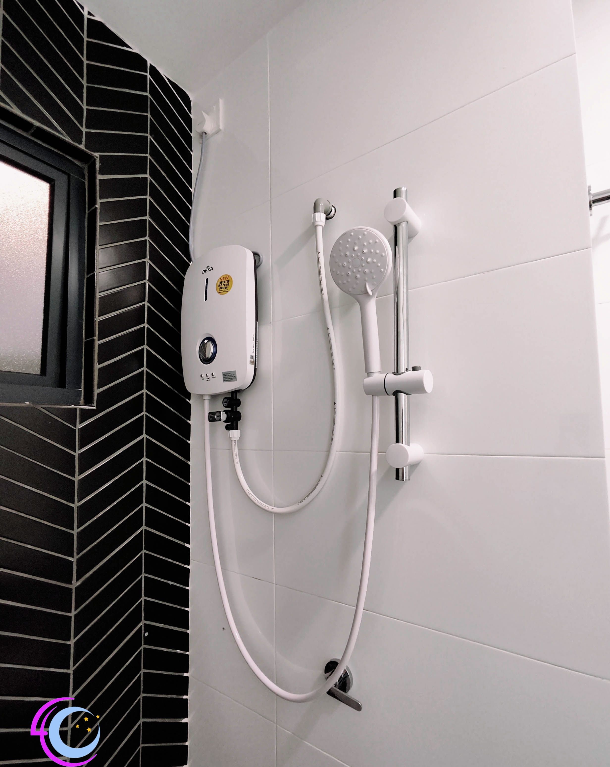 A shower with a handheld showerhead and a wall-mounted control panel.