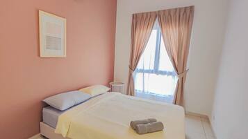 A bedroom with a bed, an air conditioning unit, a ceiling fan, a window with curtains, and a small bedside table.