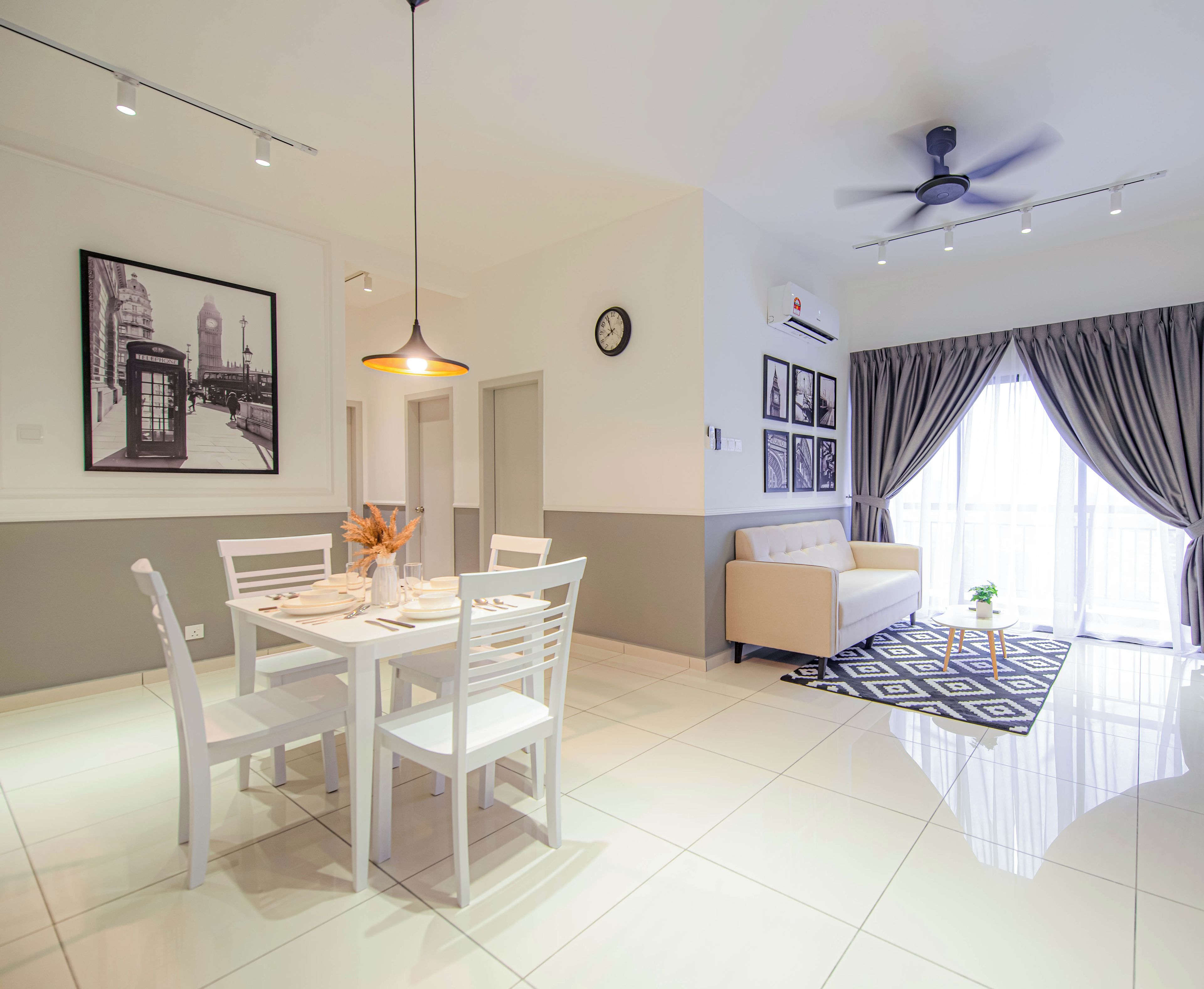A modern living room with a dining area, a ceiling fan, and a large window with curtains.