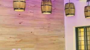 A room with wooden flooring, a window with green blinds, and three hanging wooden lamps. - 6BDR Duplex in GRA Near Shoprite & Malls (Enugu)