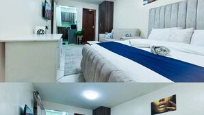 Une chambre d’hôtel avec un lit, un canapé, une petite table et un téléviseur.