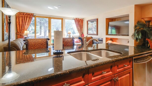 A kitchen with granite countertops, a double sink, and wooden cabinets. - 1 Mi to Vail Ski Resort: Condo w/ Resort Perks! (Vail)