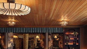 A modern interior with a bar area, seating, and decorative elements. - Near Zilker + Lady Bird | Pool + Bar | Accessible Queen Studio at The Code (Austin)