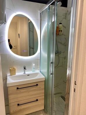 Shower, hair dryer, towels, soap