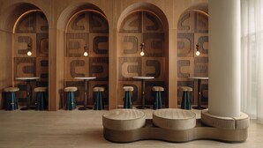 A modern interior with wooden walls, arched niches, round tables, and stools. - Private Balcony w/ Pool, Terrace, Dining, Bar | Near Lady Bird & Zilker (Austin)