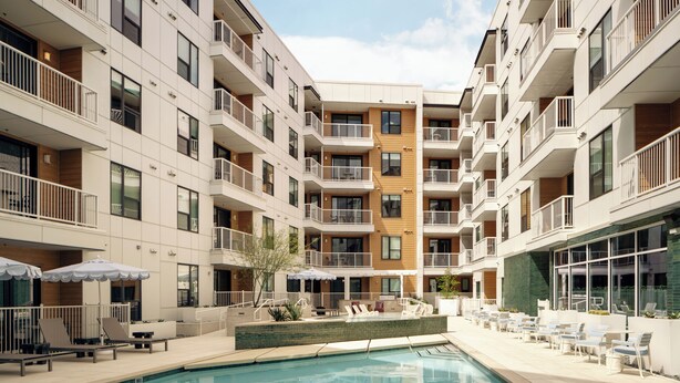 A modern multi-story hotel with balconies, a swimming pool, and outdoor seating areas. - Experience Zilker + South Lamer | Private Balcony | Pool, Dining, Bar | The Code (Austin)